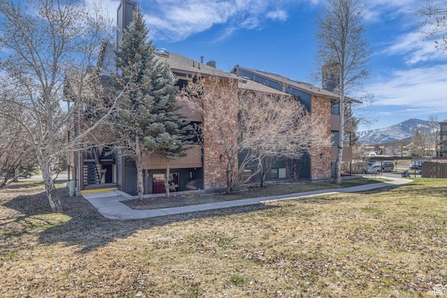 6821 N 2200 W Unit 11K, Park City, UT 84098 - back of house featuring a mountain view, stairs, a lawn, and a chimney