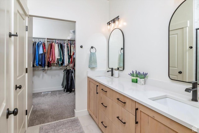 585 S 400 E, Hyrum, UT 84319 - bathroom with double vanity, a spacious closet, and tile patterned flooring