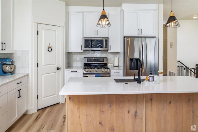 585 S 400 E, Hyrum, UT 84319 - kitchen with appliances with stainless steel finishes and white cabinetry