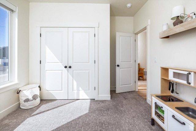 585 S 400 E, Hyrum, UT 84319 - kitchen with open shelves, carpet flooring, baseboards, and a sink