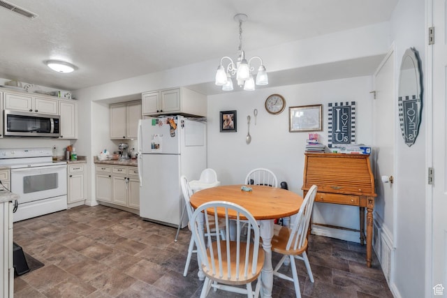 dining area featuring visible vents and an inviting chandelier
