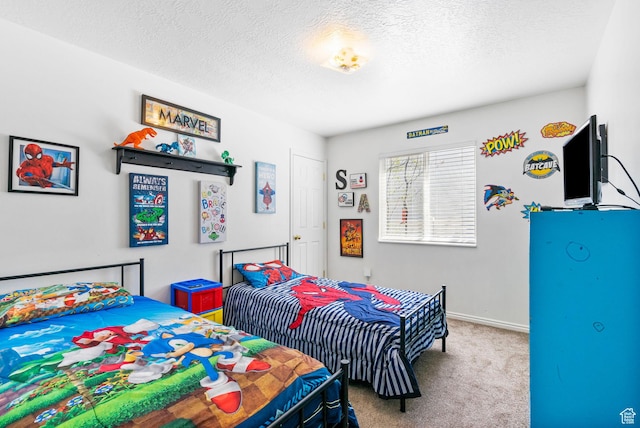 carpeted bedroom featuring a textured ceiling and baseboards
