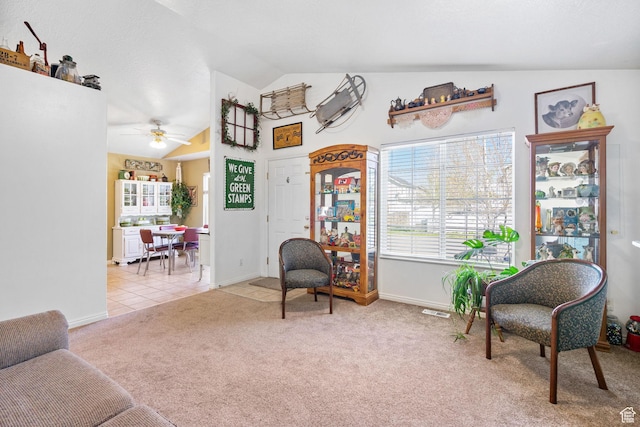 living area featuring high vaulted ceiling, a ceiling fan, visible vents, carpet floors, and baseboards
