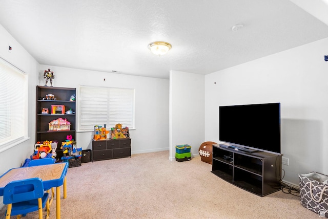 recreation room featuring carpet and baseboards