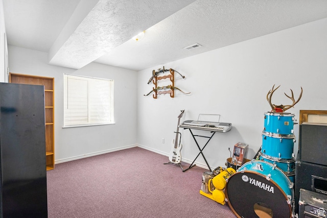 playroom with visible vents, baseboards, a textured ceiling, and carpet floors