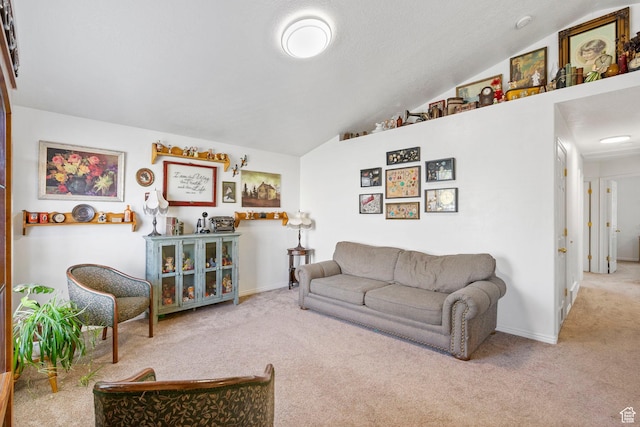 carpeted living area featuring baseboards and vaulted ceiling