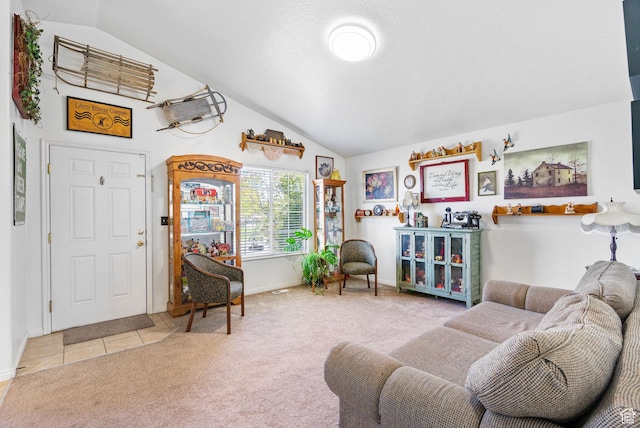 tiled living area featuring carpet flooring, baseboards, and lofted ceiling