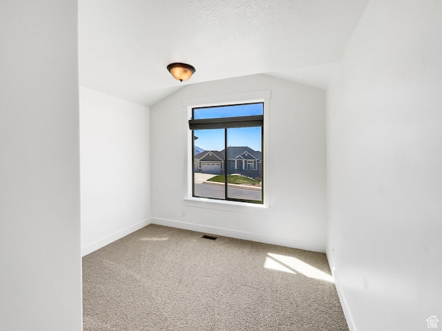 bonus room with carpet, visible vents, baseboards, and lofted ceiling