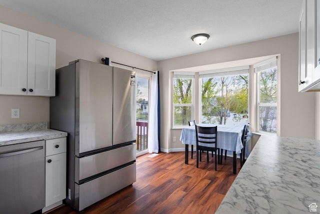 kitchen with white cabinetry, appliances with stainless steel finishes, and dark wood-style floors