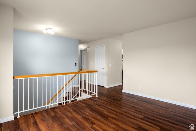 unfurnished room featuring wood finished floors and baseboards