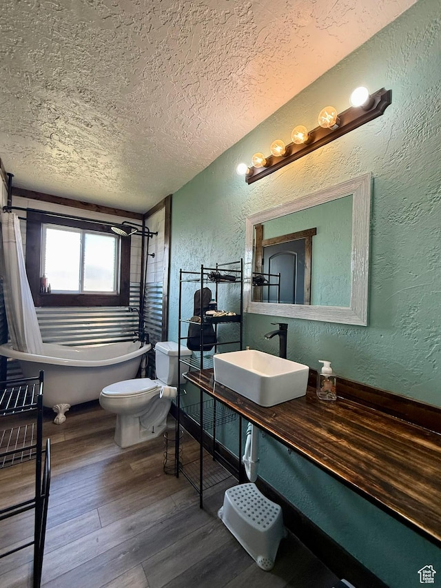130 S 500 W, Roosevelt, UT 84066 - bathroom with a sink, a textured wall, a textured ceiling, a freestanding bath, and wood finished floors