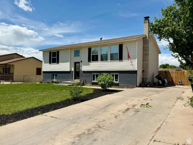 130 S 500 W, Roosevelt, UT 84066 - bi-level home with a chimney, brick siding, and concrete driveway