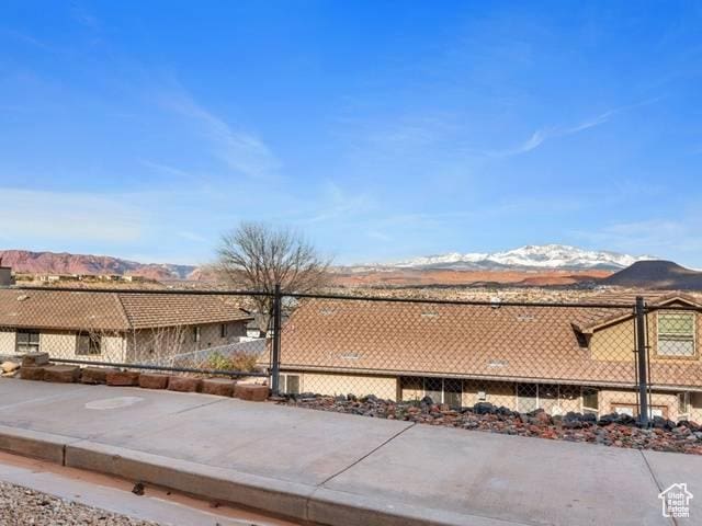 view of patio / terrace with a mountain view and fence