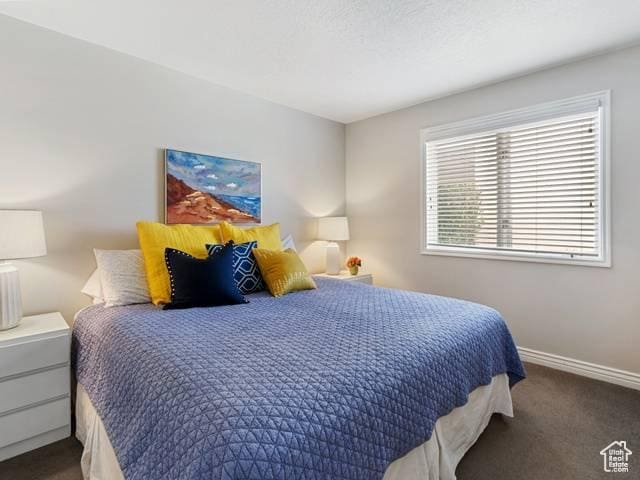 carpeted bedroom featuring baseboards