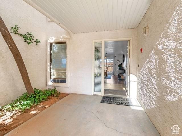 entrance to property featuring stucco siding