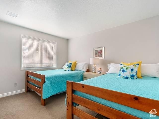 carpeted bedroom with baseboards