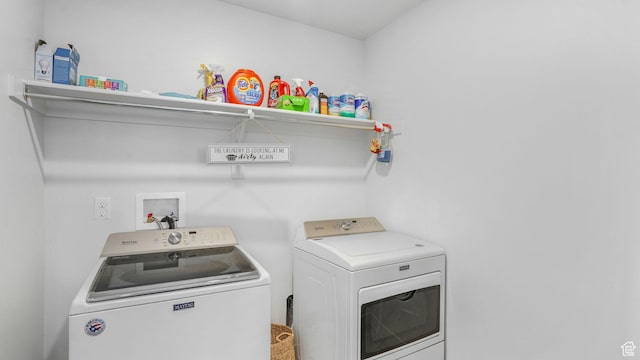 washroom with independent washer and dryer and laundry area