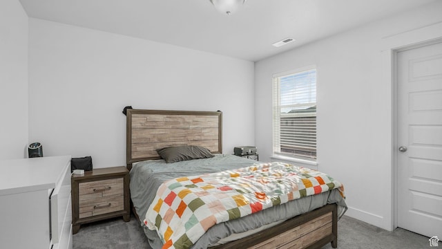 carpeted bedroom featuring visible vents
