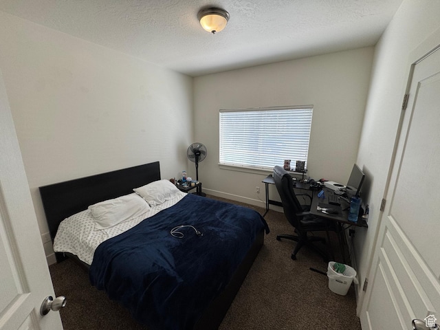 carpeted bedroom featuring a textured ceiling