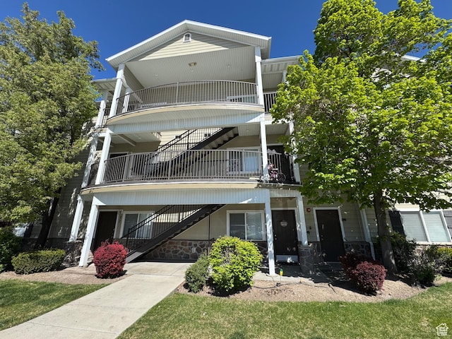 view of front of property featuring stairs and stone siding