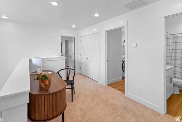 office featuring washer / clothes dryer, baseboards, light carpet, recessed lighting, and visible vents