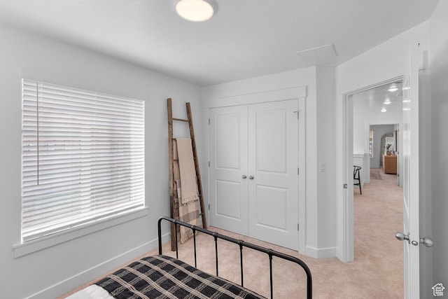 bedroom featuring a closet, carpet flooring, and baseboards