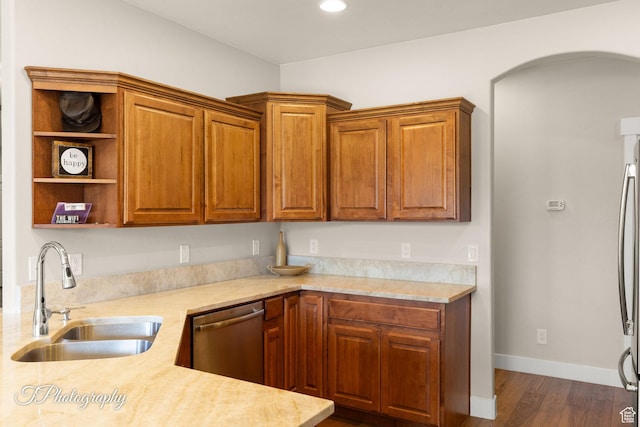 kitchen with light countertops, dishwasher, and a sink