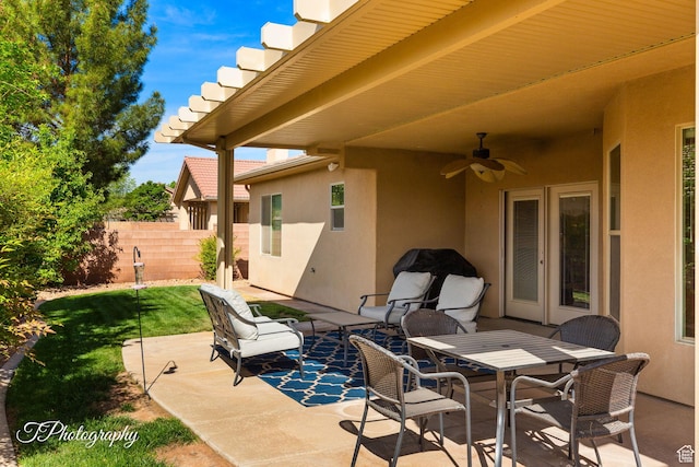 view of patio with a ceiling fan and fence