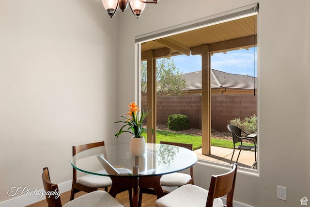 dining space featuring baseboards and wood finished floors