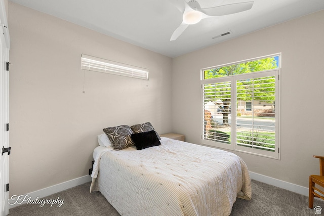 carpeted bedroom featuring visible vents, baseboards, and ceiling fan