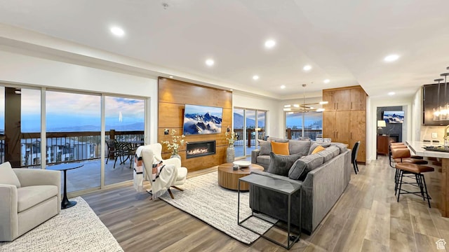 3000 Canyons Resort Dr Unit 4600, Park City, UT 84098 - living room featuring light wood-style floors, a notable chandelier, a large fireplace, and recessed lighting