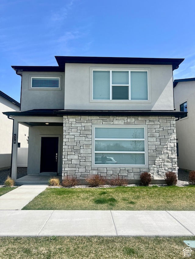 view of front of property with stucco siding and stone siding