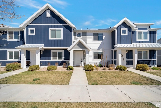 172 E Legacy Pkwy, Saratoga Springs, UT 84045 - townhome / multi-family property with a front lawn, a standing seam roof, board and batten siding, and metal roof
