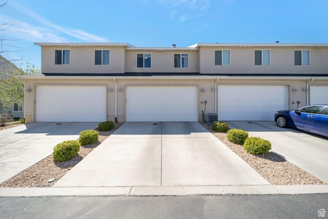 172 E Legacy Pkwy, Saratoga Springs, UT 84045 - view of property featuring stucco siding, an attached garage, concrete driveway, and central AC unit