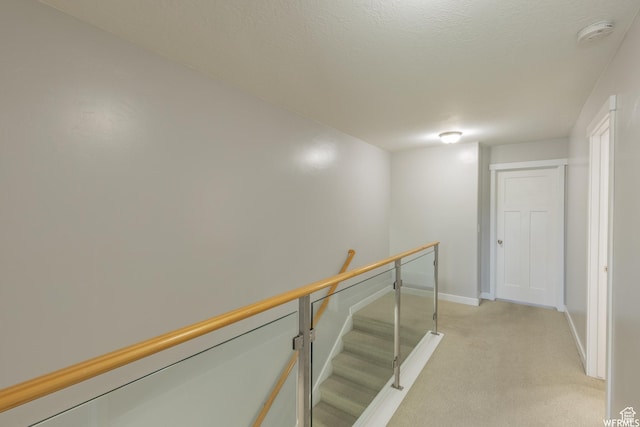 hall with light carpet and baseboards