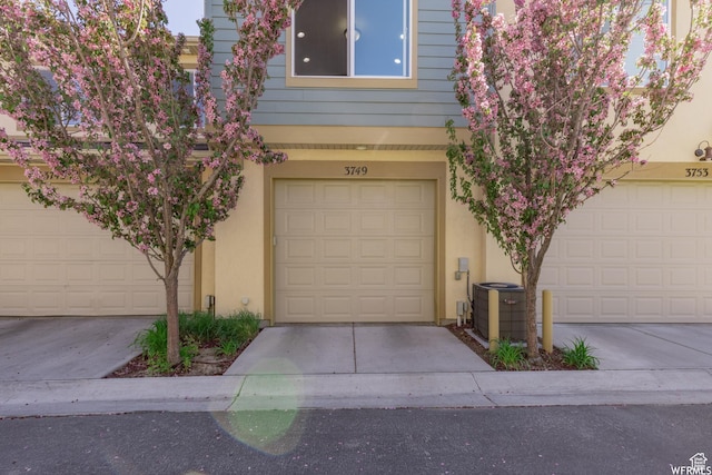 view of front of house with central air condition unit and stucco siding