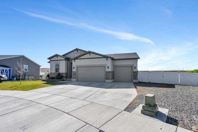 42 S 1060 W, Spanish Fork, UT 84660 - view of front facade with stone siding, fence, a gate, an attached garage, and concrete driveway