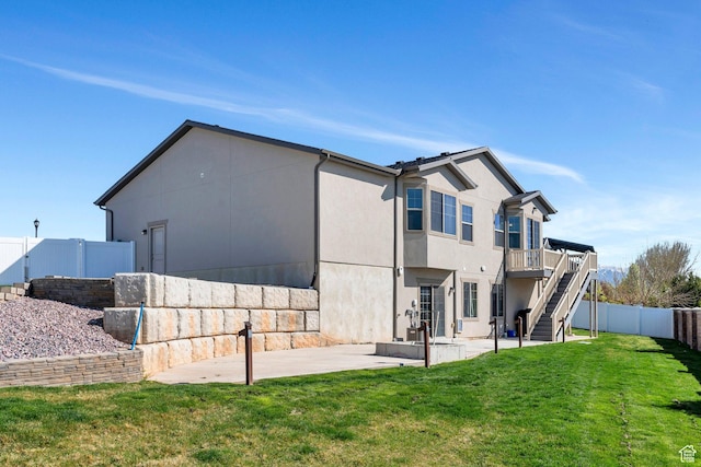 42 S 1060 W, Spanish Fork, UT 84660 - rear view of house featuring stucco siding, a patio area, stairs, a fenced backyard, and a lawn