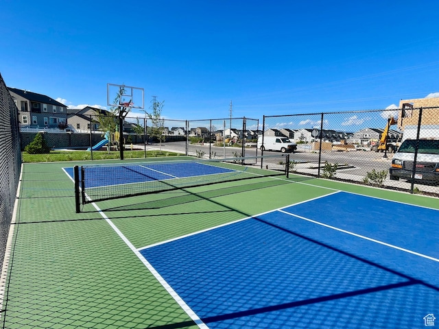 view of basketball court with a residential view, fence, and community basketball court