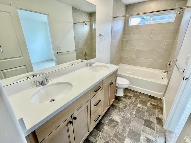 bathroom featuring a sink, toilet, double vanity, and tub / shower combination