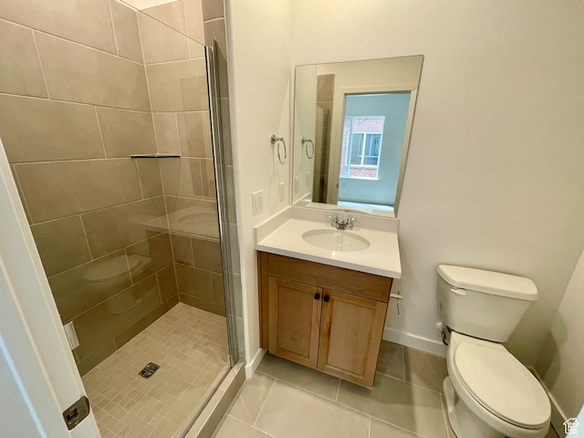 bathroom with toilet, a stall shower, vanity, and tile patterned flooring