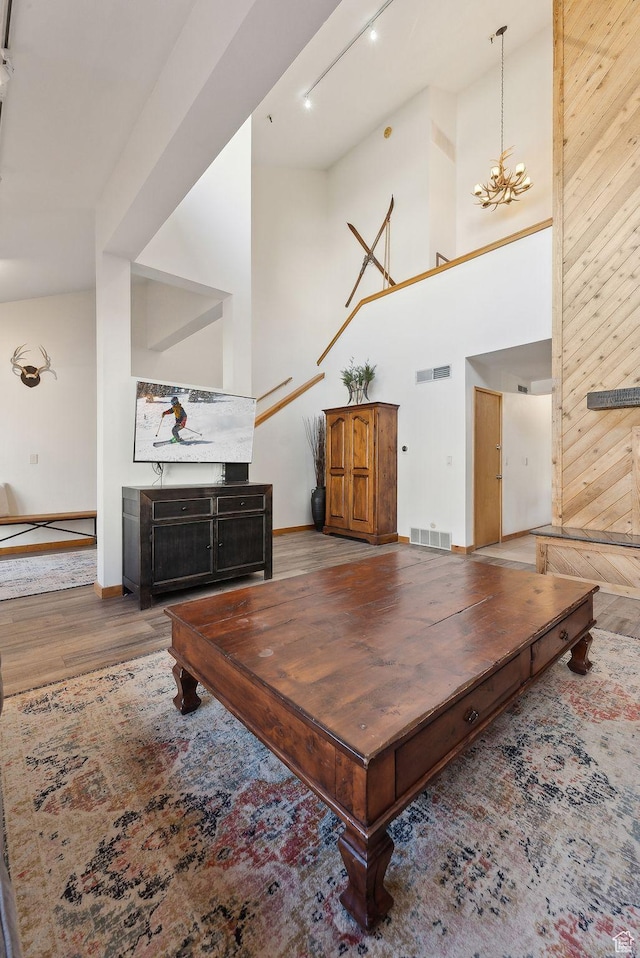 1450 Deer Valley Dr N, Park City, UT 84060 - living room featuring visible vents, baseboards, a towering ceiling, and wood finished floors