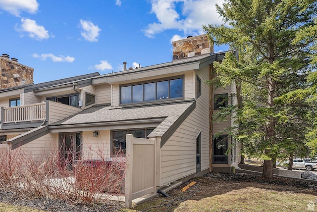 1450 Deer Valley Dr N, Park City, UT 84060 - view of front of home with roof with shingles, a chimney, and a balcony