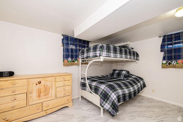 bedroom with marble finish floor and baseboards