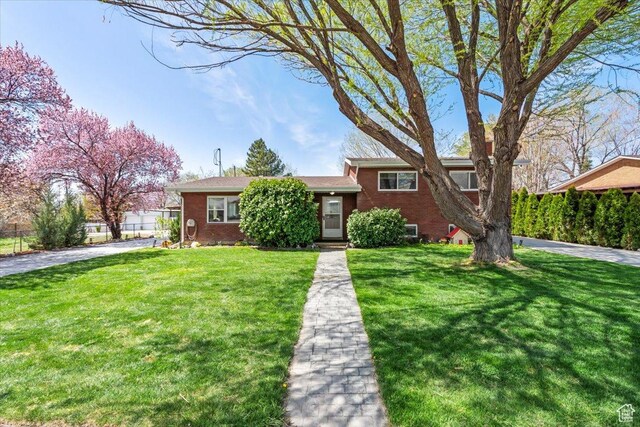 400 S 300 E, Pleasant Grove, UT 84062 - split level home featuring a front yard and brick siding