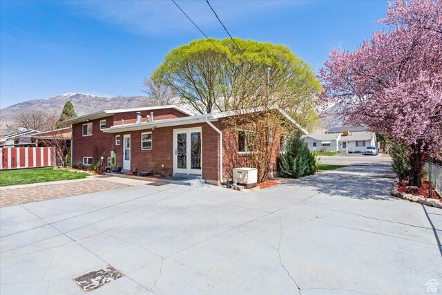 400 S 300 E, Pleasant Grove, UT 84062 - back of property with a mountain view, french doors, brick siding, a yard, and fence