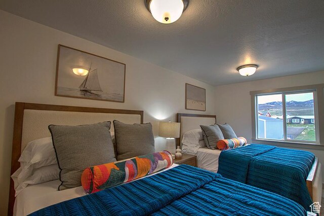 55 E Buttercup Ln Unit 42, Garden City, UT 84028 - bedroom featuring a textured ceiling