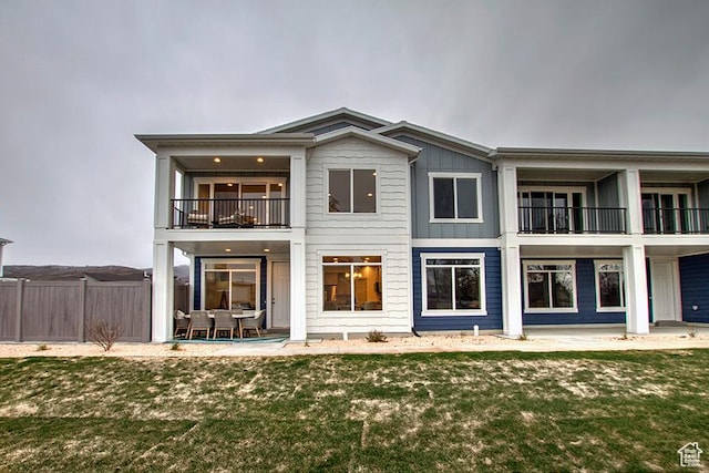 55 E Buttercup Ln Unit 42, Garden City, UT 84028 - back of property with fence, a patio, a lawn, and a balcony