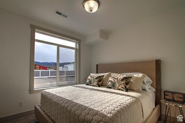 55 E Buttercup Ln Unit 42, Garden City, UT 84028 - carpeted bedroom featuring baseboards and visible vents