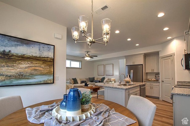 55 E Buttercup Ln Unit 42, Garden City, UT 84028 - dining area with visible vents, recessed lighting, light wood-style floors, and ceiling fan with notable chandelier